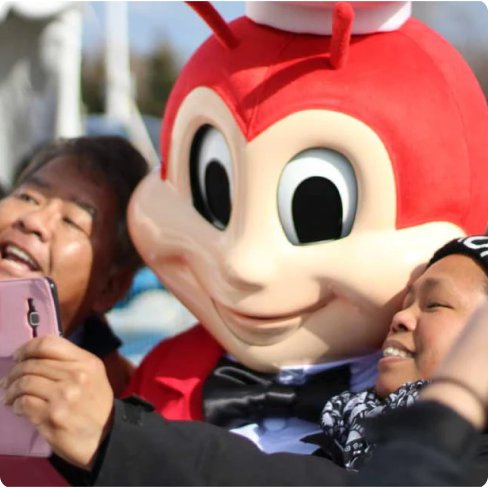 The Jollibee mascot sharing a joyful moment with fans